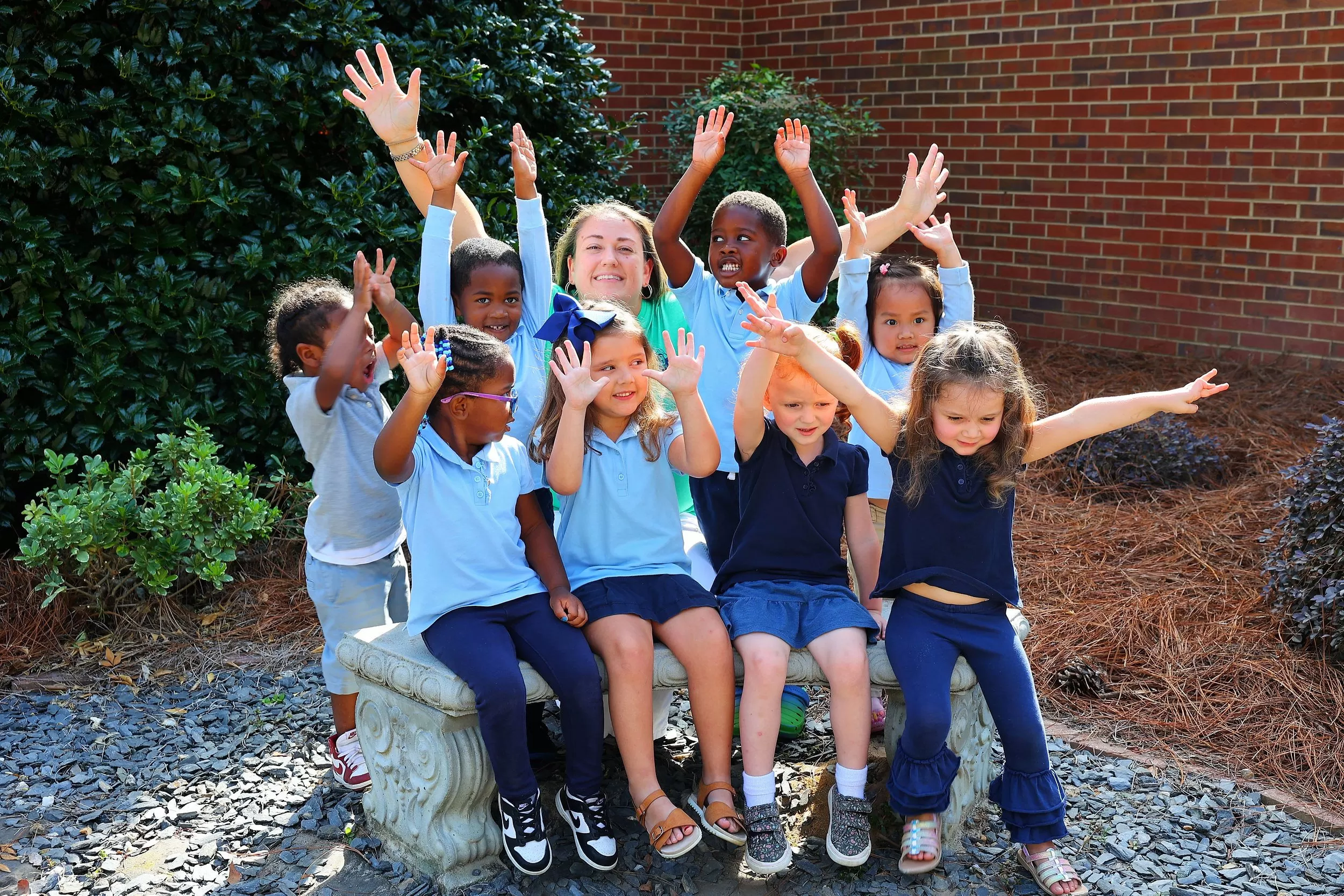 Group of children with teachers all wearing bright colors